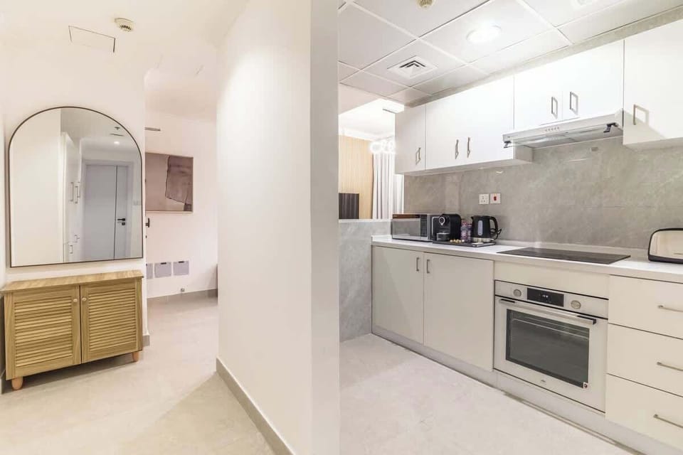 A combined view of the kitchen and hallway highlights the seamless integration of space and utility.