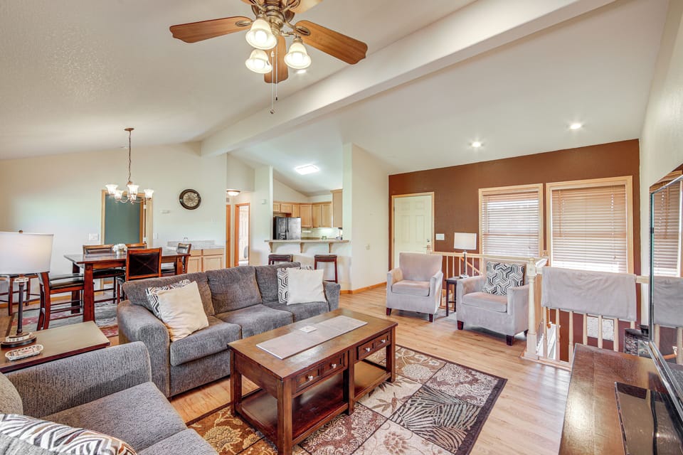 Relax in this spacious open-concept living area with vaulted ceilings and warm wood floors throughout.