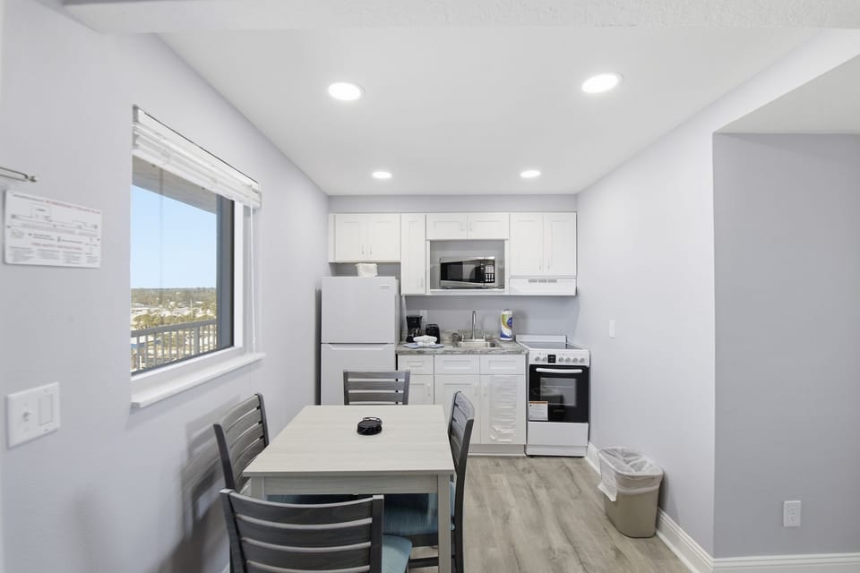 Functional and bright, the dining nook provides comfort and style, making it a perfect spot for meals or planning beach adventures against a backdrop of beautiful views.