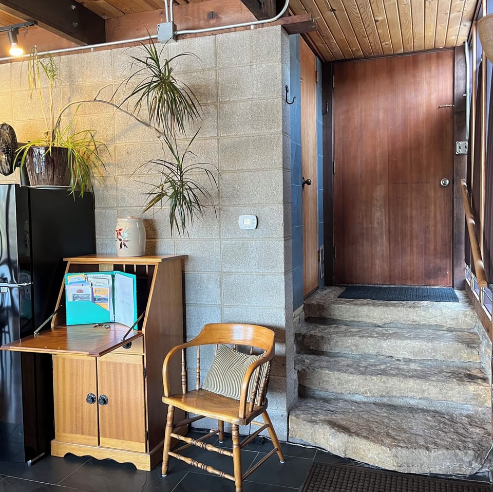 Private entrance (interior). Stone steps, cinderblock wall, letter desk.