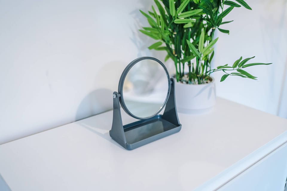 Vanity Corner: Stylish mirror with greenery enhances your beauty routine in this chic space!
