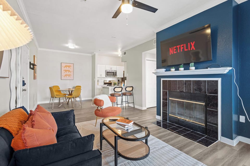 Spacious living room equipped with a Smart TV and sleek fireplace for entertainment and comfort. The open layout and modern finishes make this an ideal spot for streaming your favorite shows or gathering with friends.
