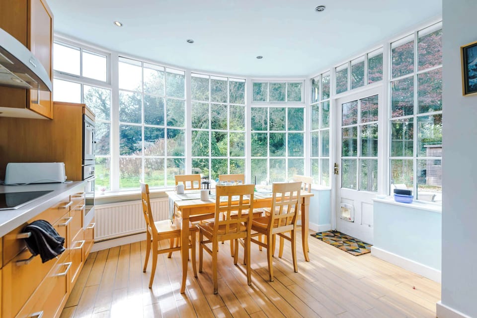Sunlit Kitchen: Gather around this bright, airy space with stunning garden views! Perfect for meals!