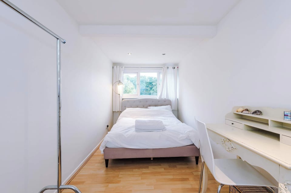 Charming Bedroom: Bright space with views, inviting decor, and a stylish workspace awaits!