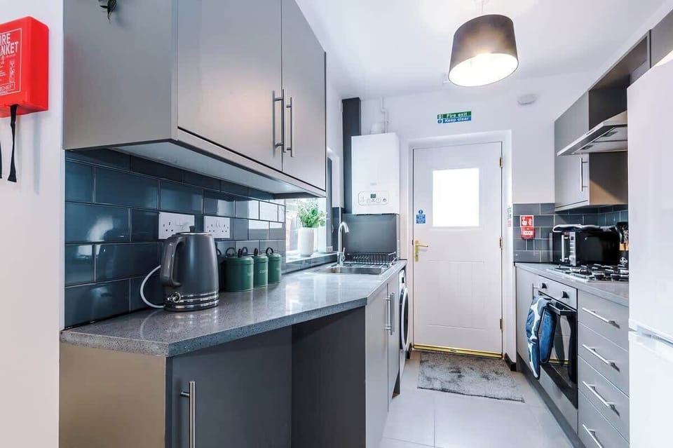 Kitchen: Sleek countertops and a sunny vibe make meal prep a delight in this modern space!