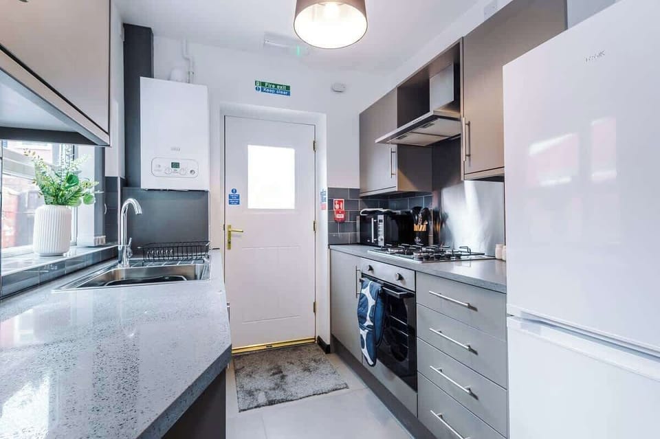 Kitchen: Sleek modern design with stylish appliances—dine and entertain in style!