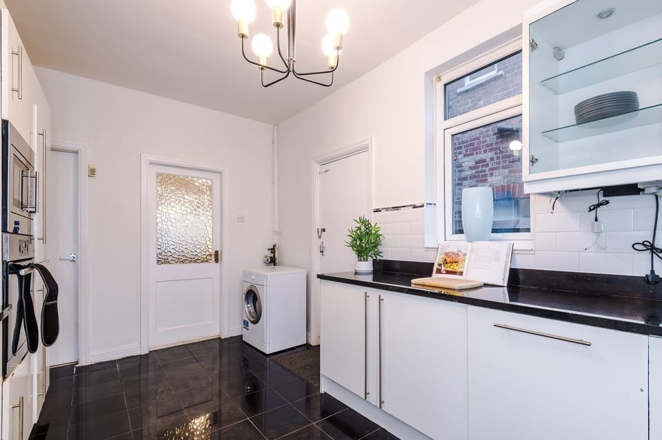 Kitchen: Sleek cabinetry and a chic design, perfect for culinary creations and casual dining!