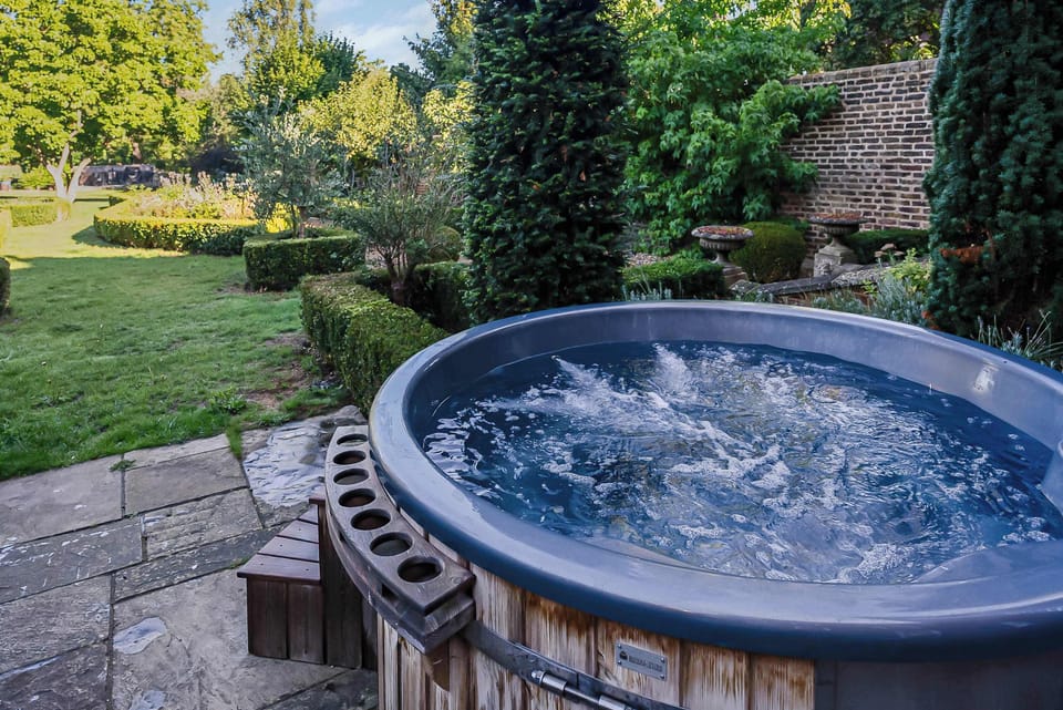 Outdoor Jacuzzi: Soak in luxury surrounded by lush gardens and serene nature!