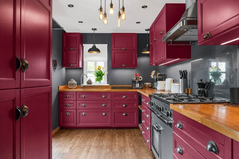 Country Kitchen: Burgundy cabinetry, gas range, and rustic worktops for gourmet cooking!