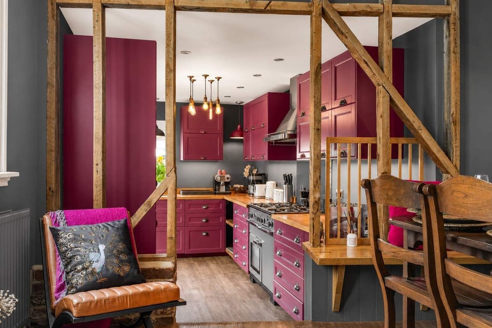 Kitchen Charm: Vibrant cabinetry and exposed beams make every meal memorable!