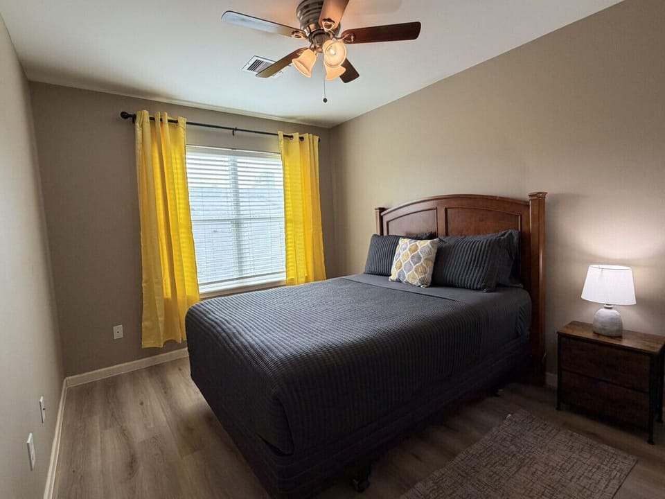 Third bedroom with a wall-mounted smart TV — a private retreat for whoever needs it