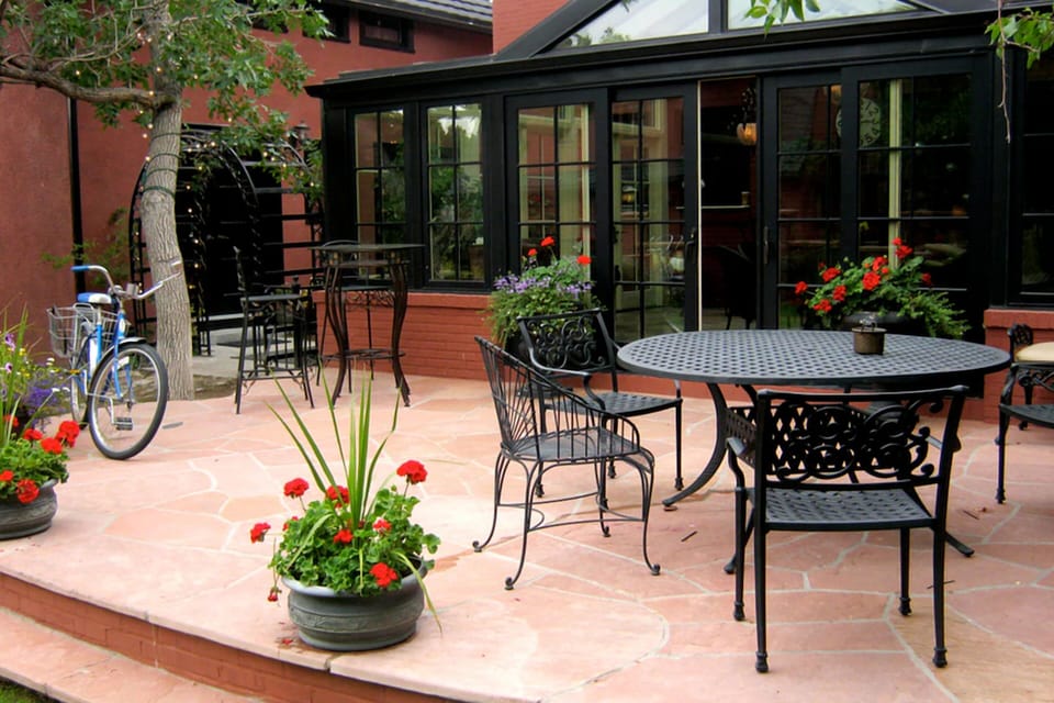 Gather outside for drinks on the charming, flower-filled patio.