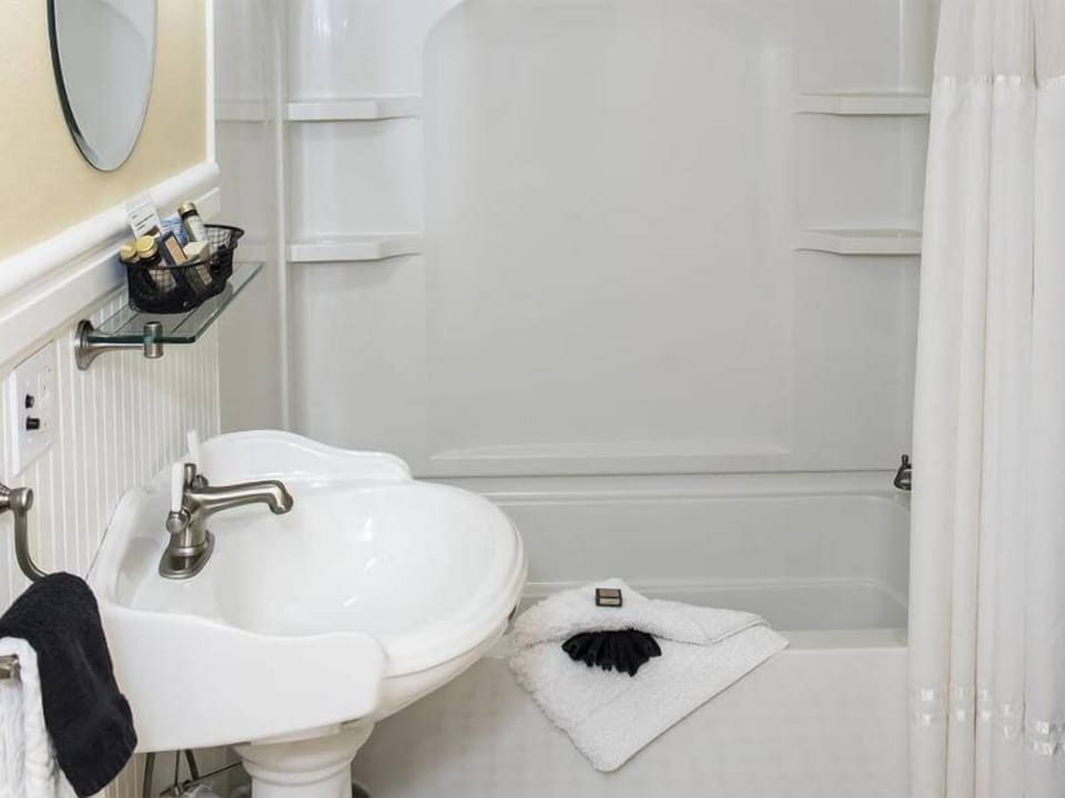 Refresh comfortably with a clean tub-shower and classic sink.