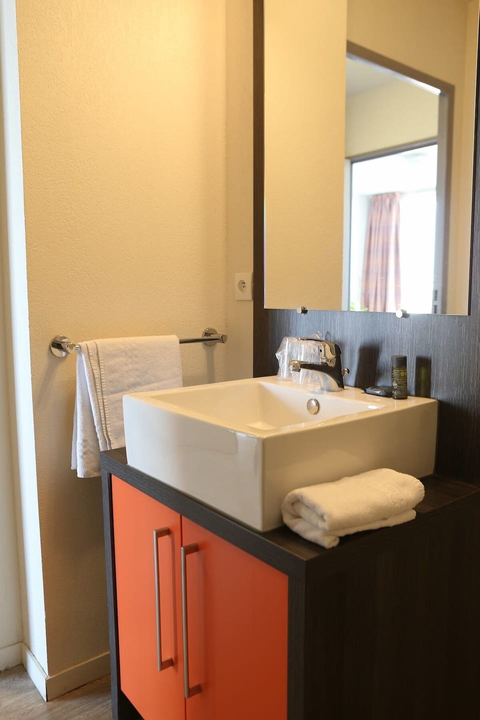 Get ready with a bright vanity and fresh towels within reach.