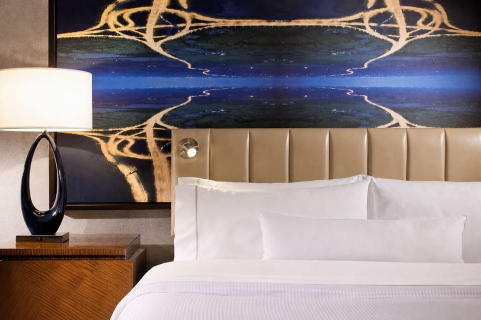 Sink into plush pillows beneath bold, modern artwork.