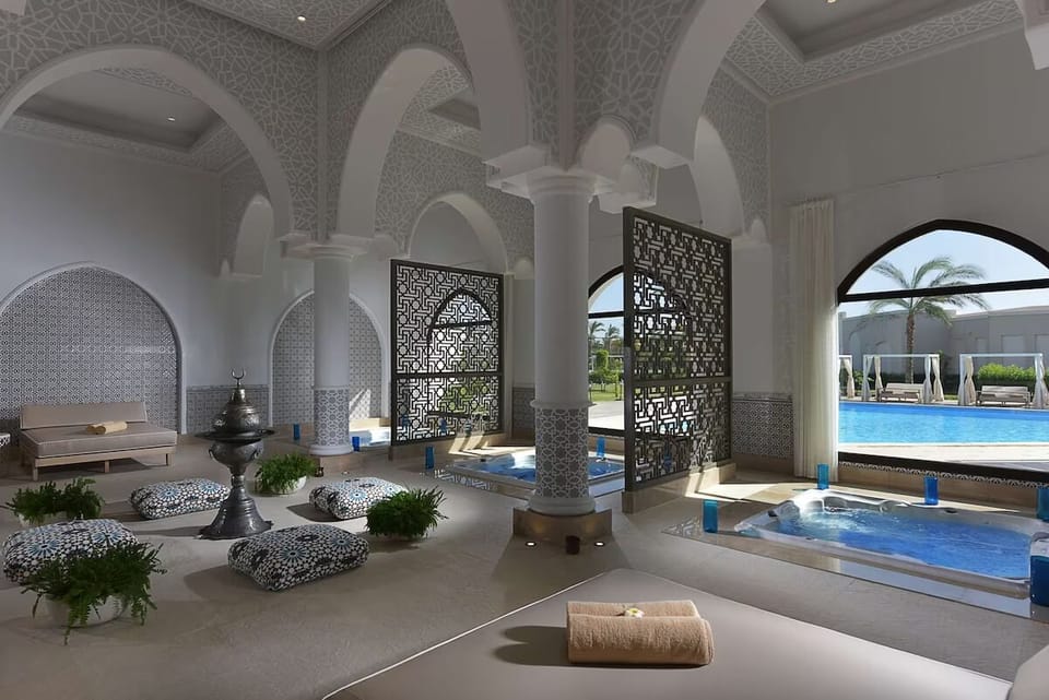 Unwind in serene thermal pools framed by elegant arches.