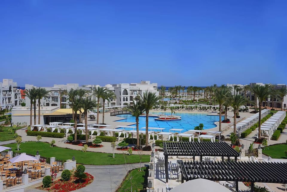 Stroll through palm-lined grounds surrounding the expansive lagoon pool.