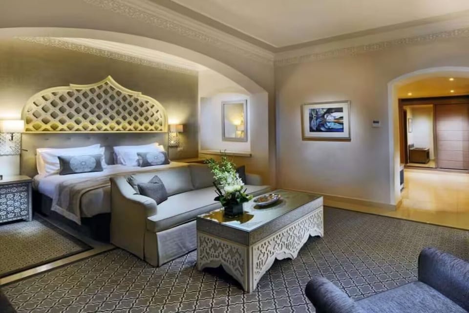 Sink into crisp linens beneath an elegant statement headboard.