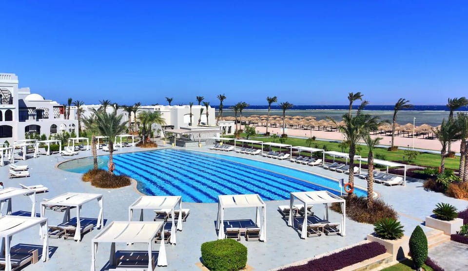Dive into sunlit pool days with ocean views beyond.
