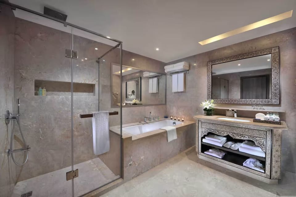 Indulge in a calm soak surrounded by warm stone finishes.