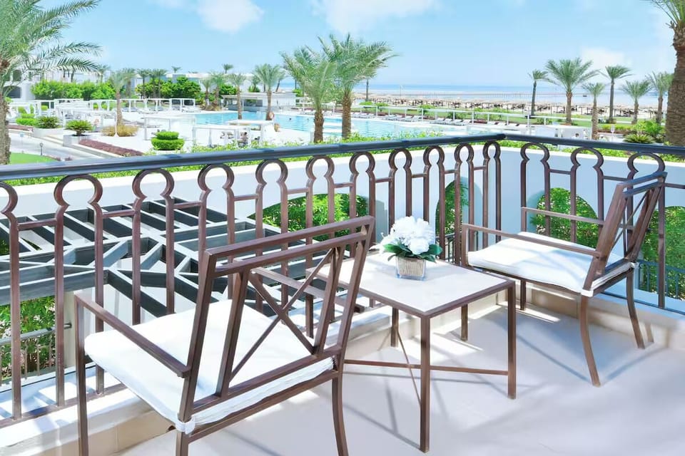 Sip morning coffee on the balcony overlooking palms and sea.