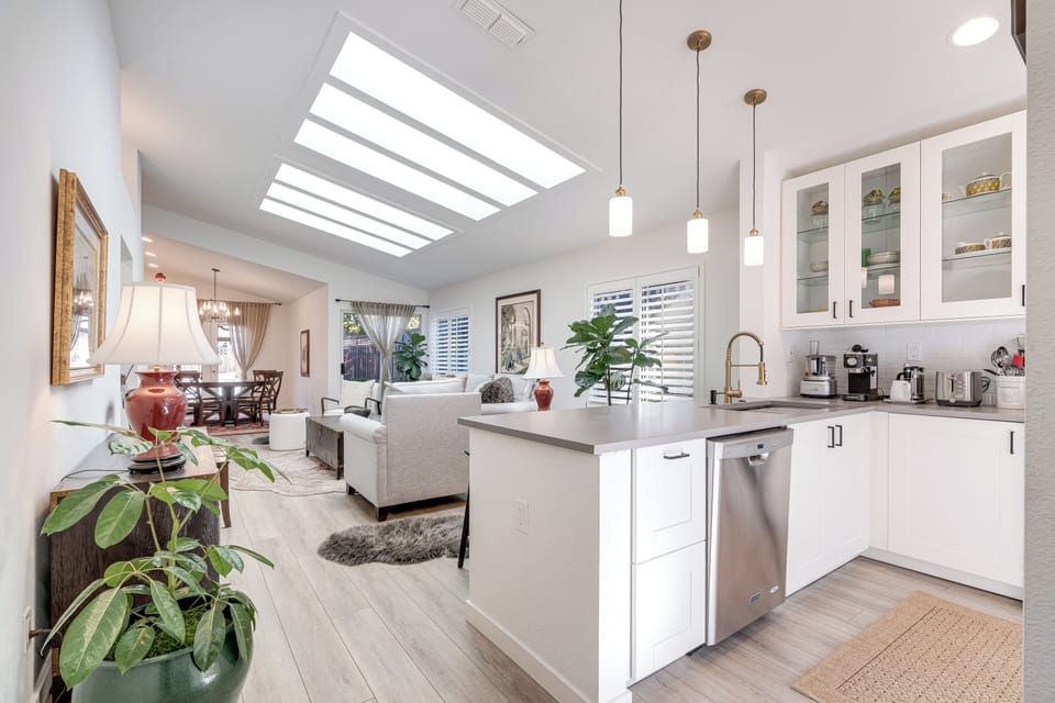 Your bright open-plan space flows seamlessly from kitchen to living area, bathed in natural light from the stunning skylight above.