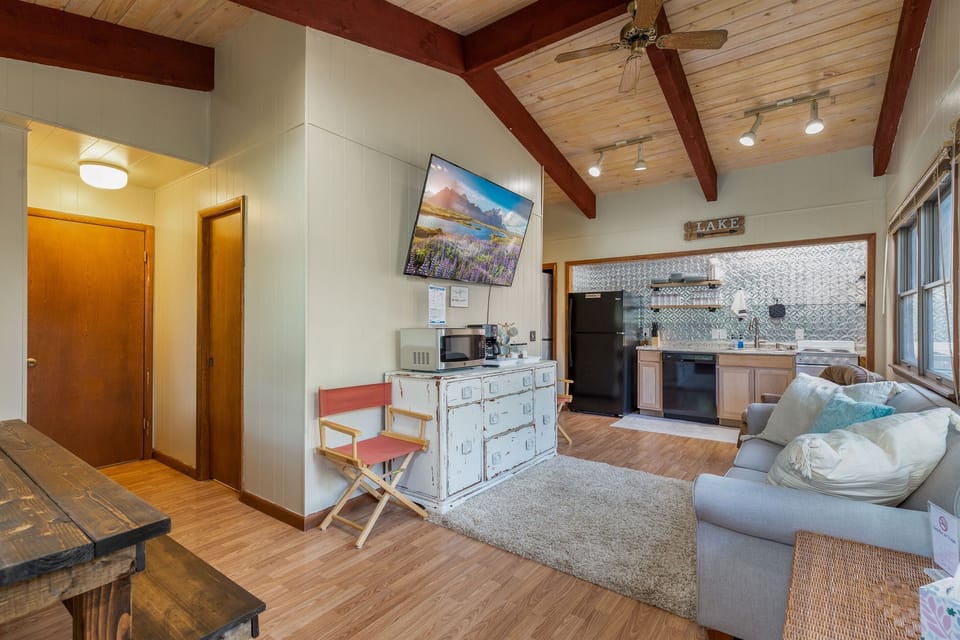 Open living area with huge TV and seating for five!