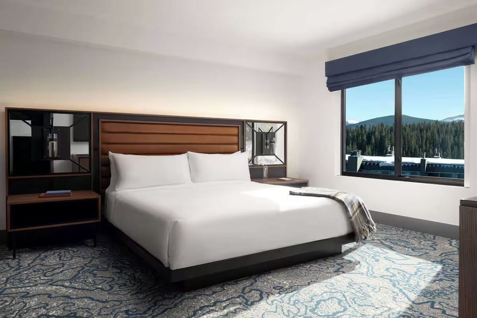 Wake up to sunlit mountain views from a plush bed.