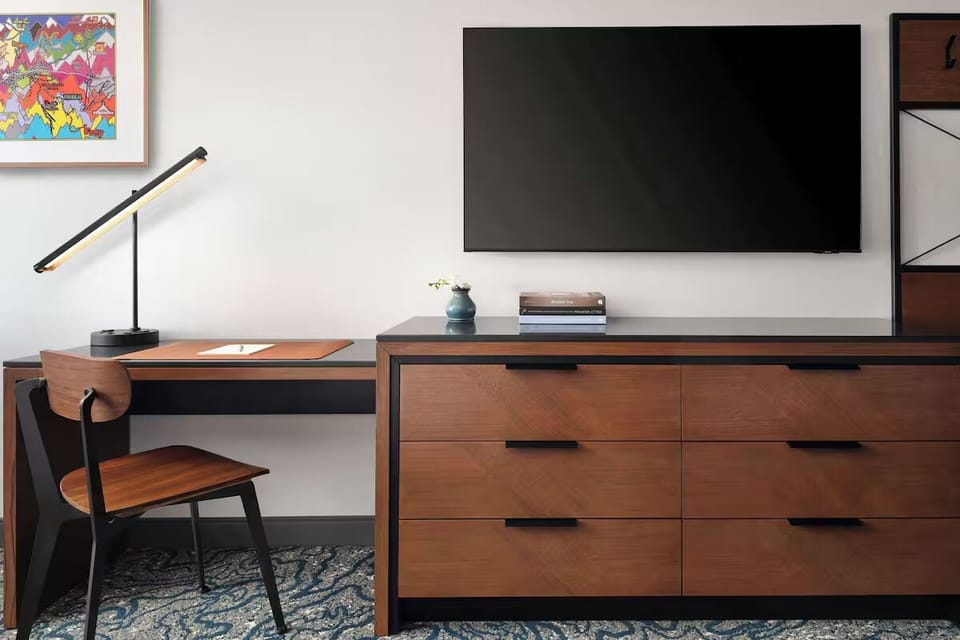 Plug in and focus at the sleek desk with big-screen TV.
