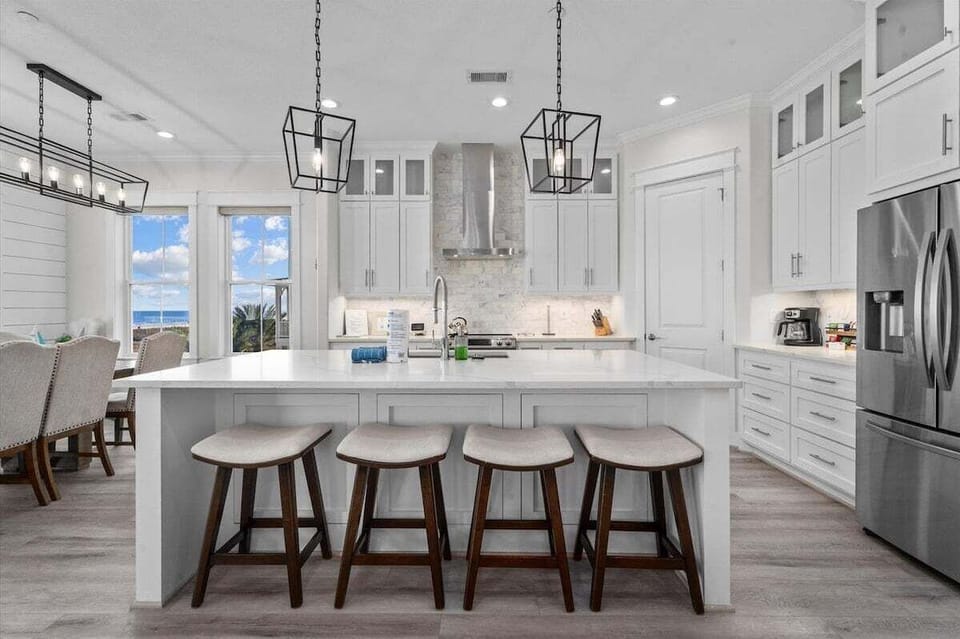 Gourmet kitchen with large island, quartz countertops, and bar seating perfect for entertaining.