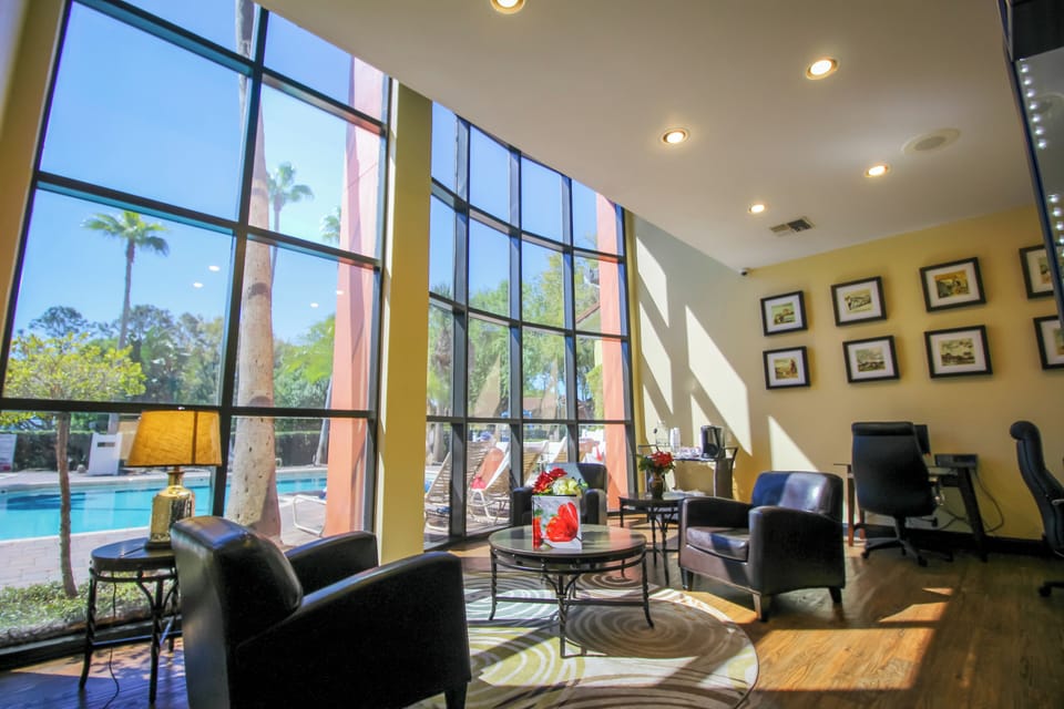 Unwind in a sunlit lounge with poolside views.