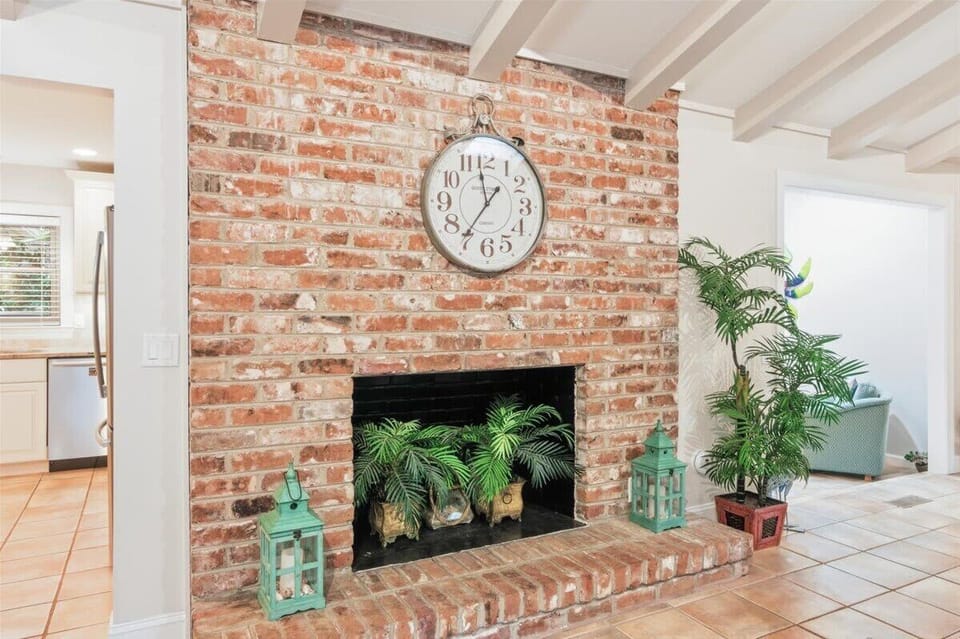 Sun-drenched living room with vaulted ceilings, skylights, and coastal Lowcountry charm.