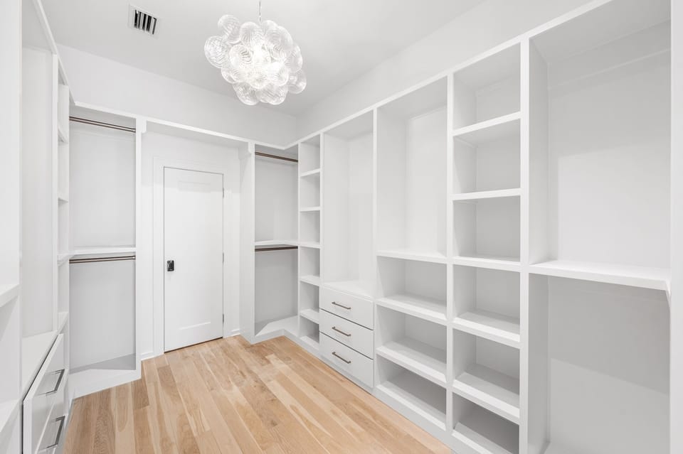 Your spacious walk-in closet offers endless storage with custom shelving, hanging rods, and elegant lighting to organize your wardrobe in style.