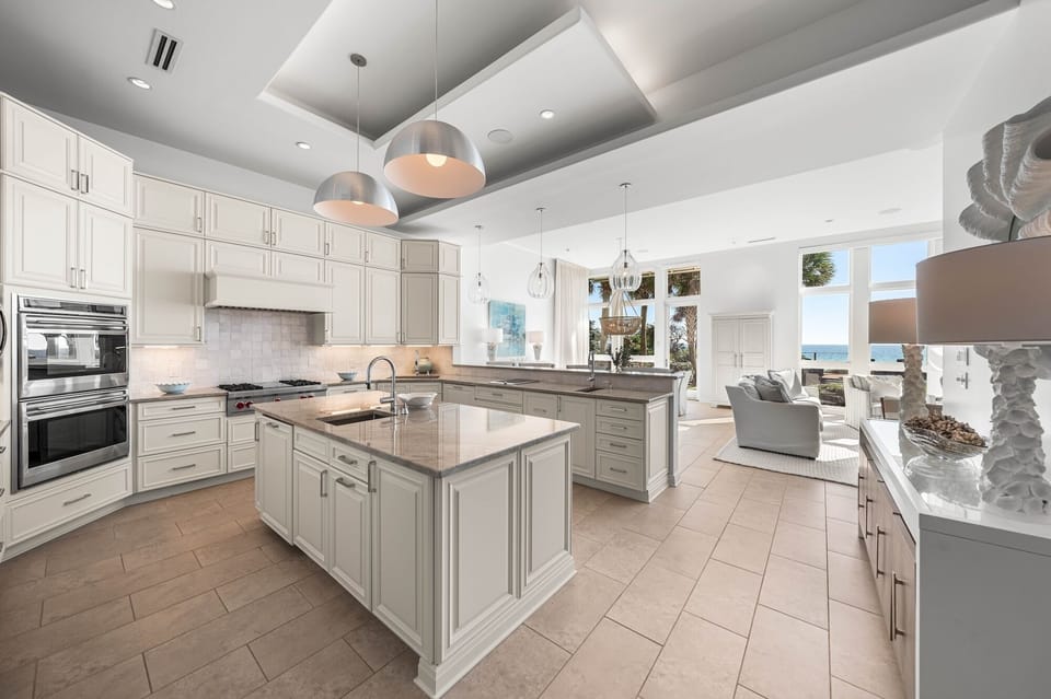 Your gourmet kitchen features premium appliances and stunning views through floor-to-ceiling windows, perfect for creating memorable meals during your stay.