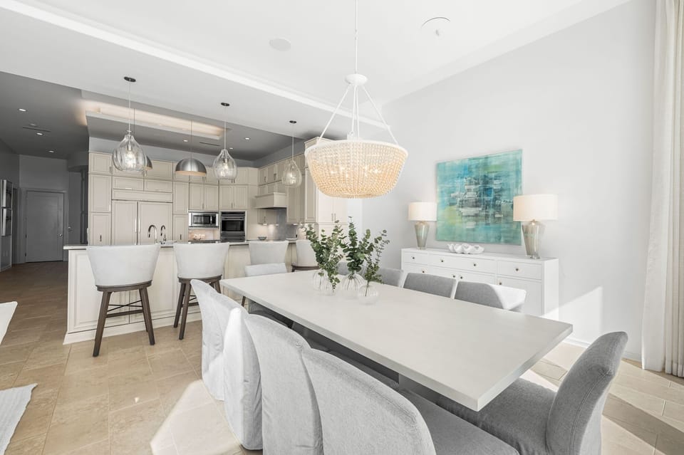Your elegant dining space flows seamlessly into the modern kitchen, perfect for gathering with loved ones under the warm glow of stunning chandeliers.