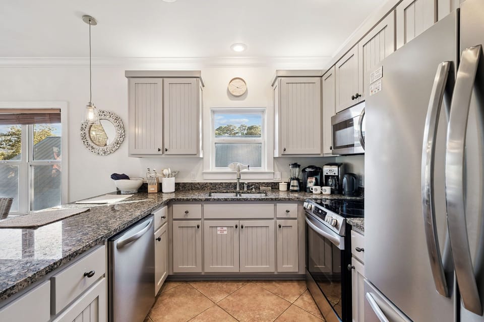 Your fully equipped kitchen features granite counters, stainless appliances, and peaceful water views—perfect for preparing meals while enjoying the scenery.