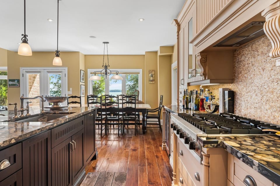 Spacious kitchen with gourmet stove and sunny breakfast nook