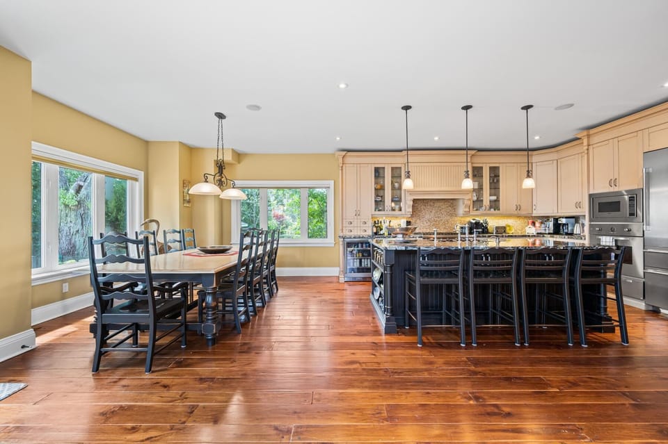 Spacious kitchen and dining area with warm hardwood floors