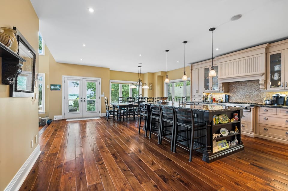 Spacious kitchen with sleek island and warm hardwood floors