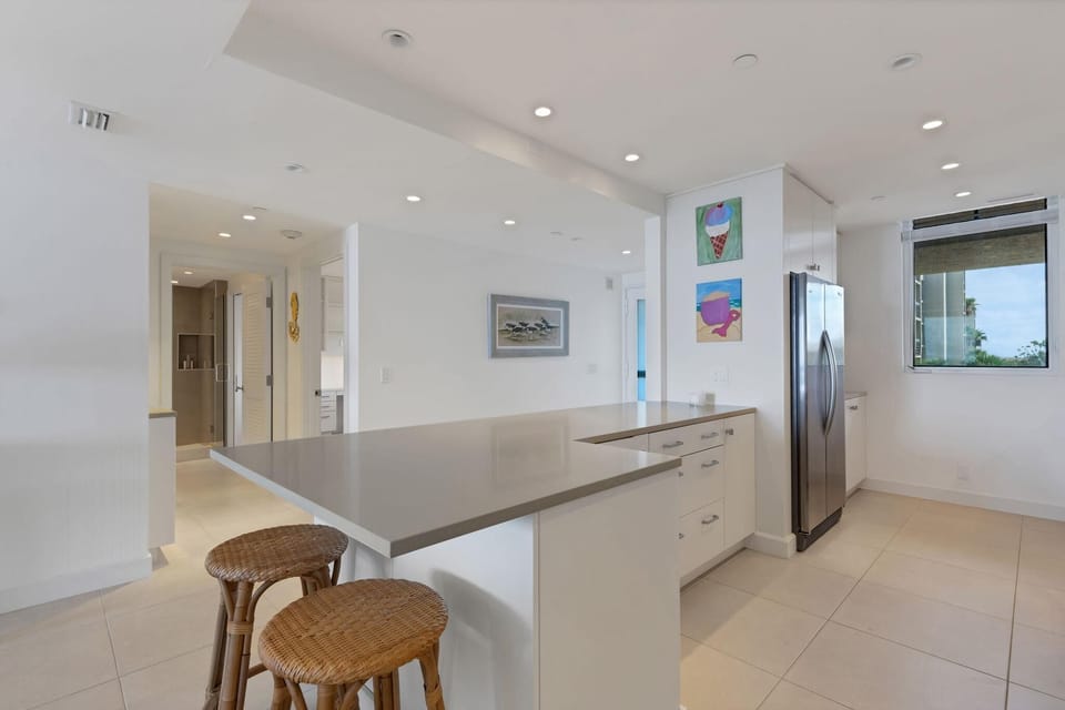 Bright, modern kitchen with sleek countertops and bar seating