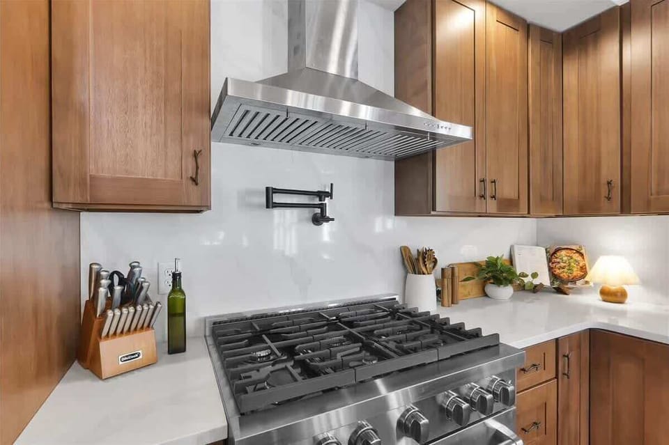 Chef’s Kitchen with Gas Range and Stainless Vent Hood