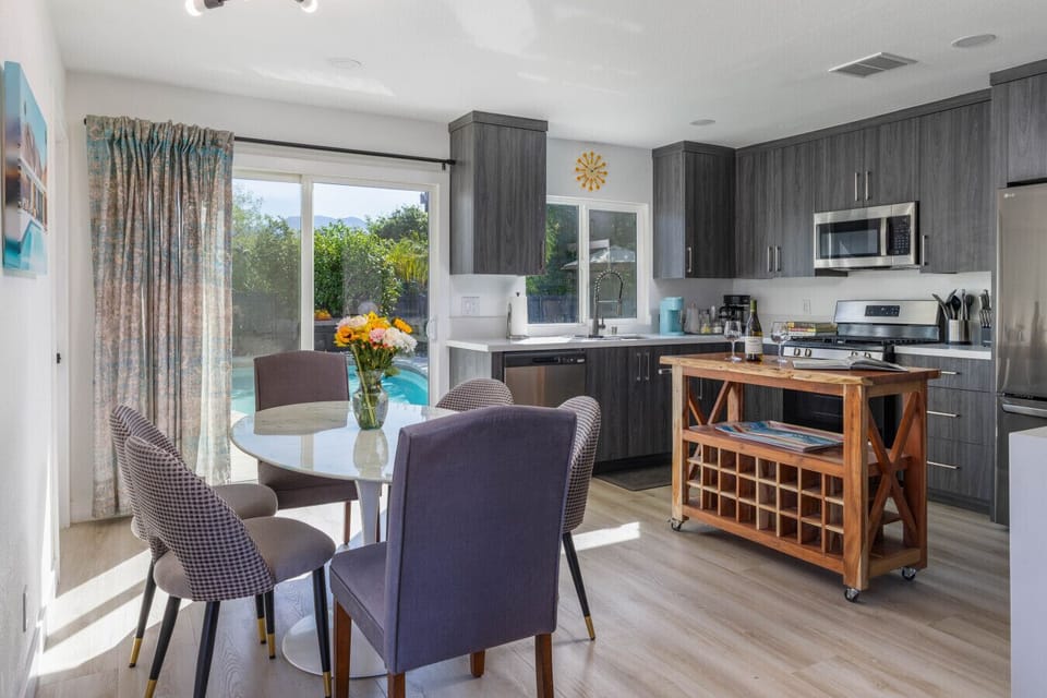 Contemporary kitchen with plenty of storage, natural light, and a cozy wine-ready dining nook.