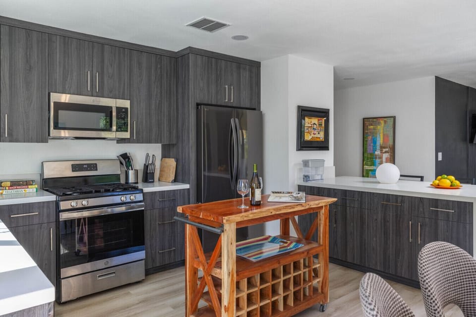 Open, airy kitchen designed for both everyday living and hosting, complete with premium appliances.
