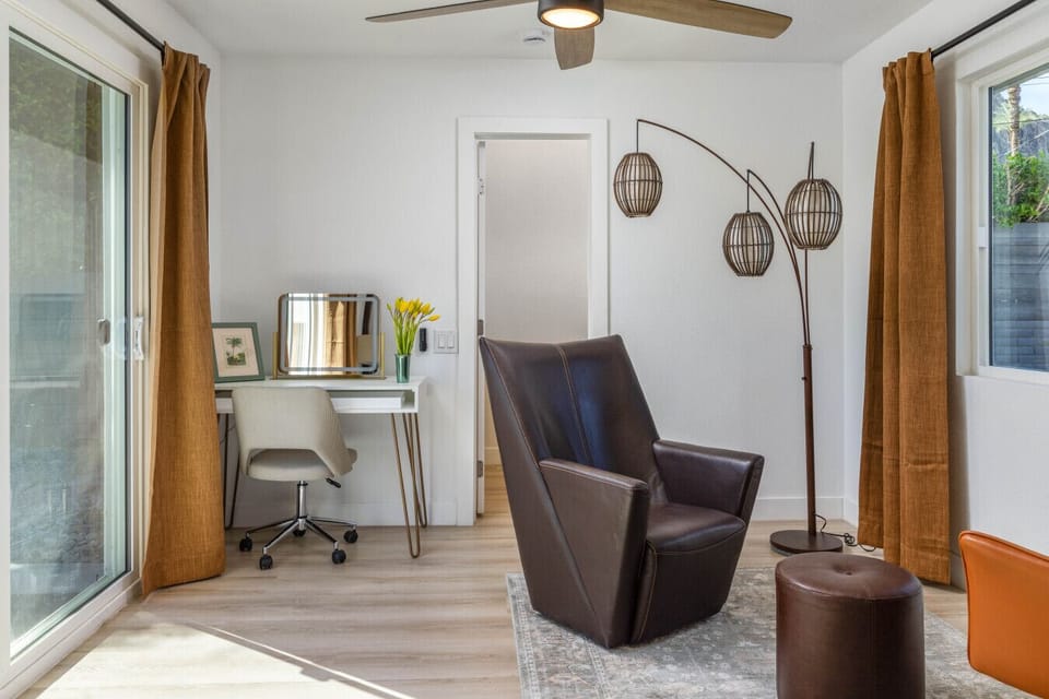 Minimalist bedroom setup with earthy tones and a relaxing seating area.