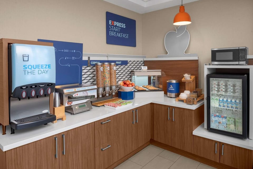 Free breakfast area with juice, cereal, fruit, and hot food