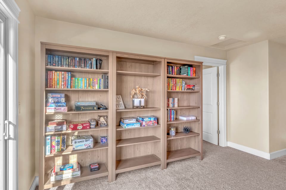 Curl up with your favorite book from this thoughtfully curated library, featuring classics and games for cozy evenings in.
