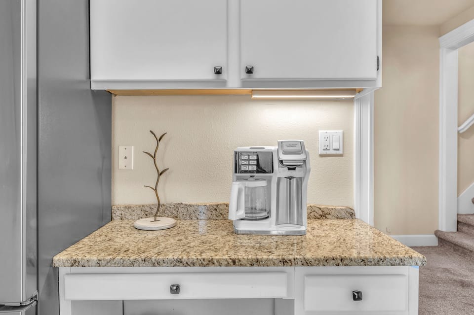 Your private coffee station awaits with premium granite counters and modern appliances for perfect morning brews.