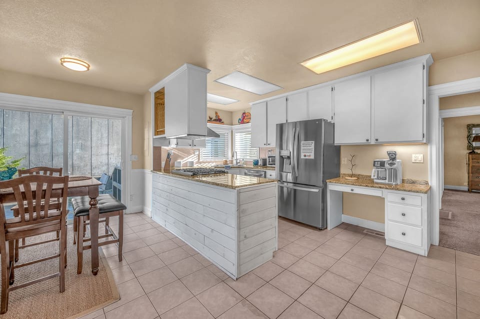 Your spacious kitchen features granite counters, stainless appliances, and a breakfast bar perfect for morning coffee and meal prep.