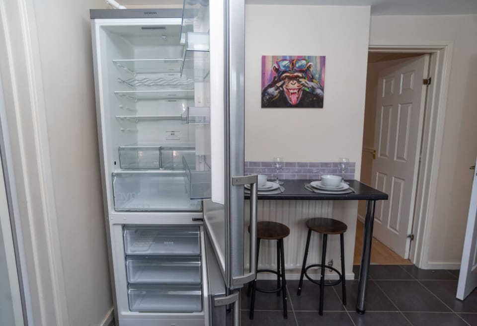 Spotlessly clean appliances, professionally cleaned between every stay, plus a breakfast bar offering additional seating to the dining table and a comfortable workspace.