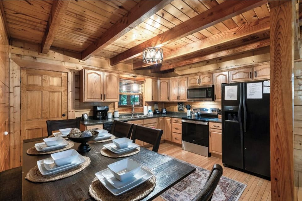 Your rustic kitchen features warm wood beams, granite counters, and full appliances for creating memorable meals together.